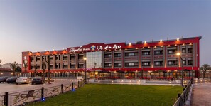 Experience the welcoming atmosphere of our outdoor area with seating arrangements, surrounded by a series of balconies.
