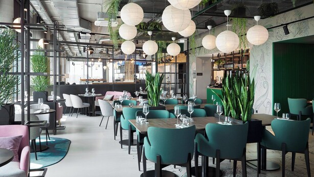 A modern restaurant with teal chairs, white tablecloths, and hanging paper lanterns. - Moxy Cologne-Bonn Airport (Cologne)