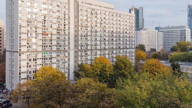 A high-rise building with a grid-like facade, multiple balconies, and a mix of residential and commercial spaces. - ShortStayPoland Krochmalna B17 (Warsaw)