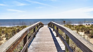 A wooden boardwalk leading to a beach with clear skies. - One-of-a-Kind Trolley Home, Oceanfront w/ Dune View by Tybee Cottages (Tybee Island)