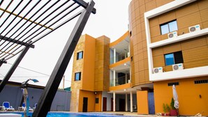 Un hotel moderno con piscina, area salotto all'aperto e un design architettonico originale.