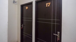 Two dark-colored doors with numbers 19 and 17, indicating room numbers.