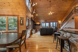 A wooden interior with a dining area, bar, and seating.