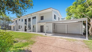 A two-story residential building with a covered driveway and a garage. - Seahaven 1 close to Shoal Bay Beach (Shoal Bay)