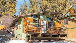 A cabin with a wooden exterior, a front porch, and a mailbox. - Cute Cozy Cabin- View of the Slopes-Pets OK! (Big Bear Lake)