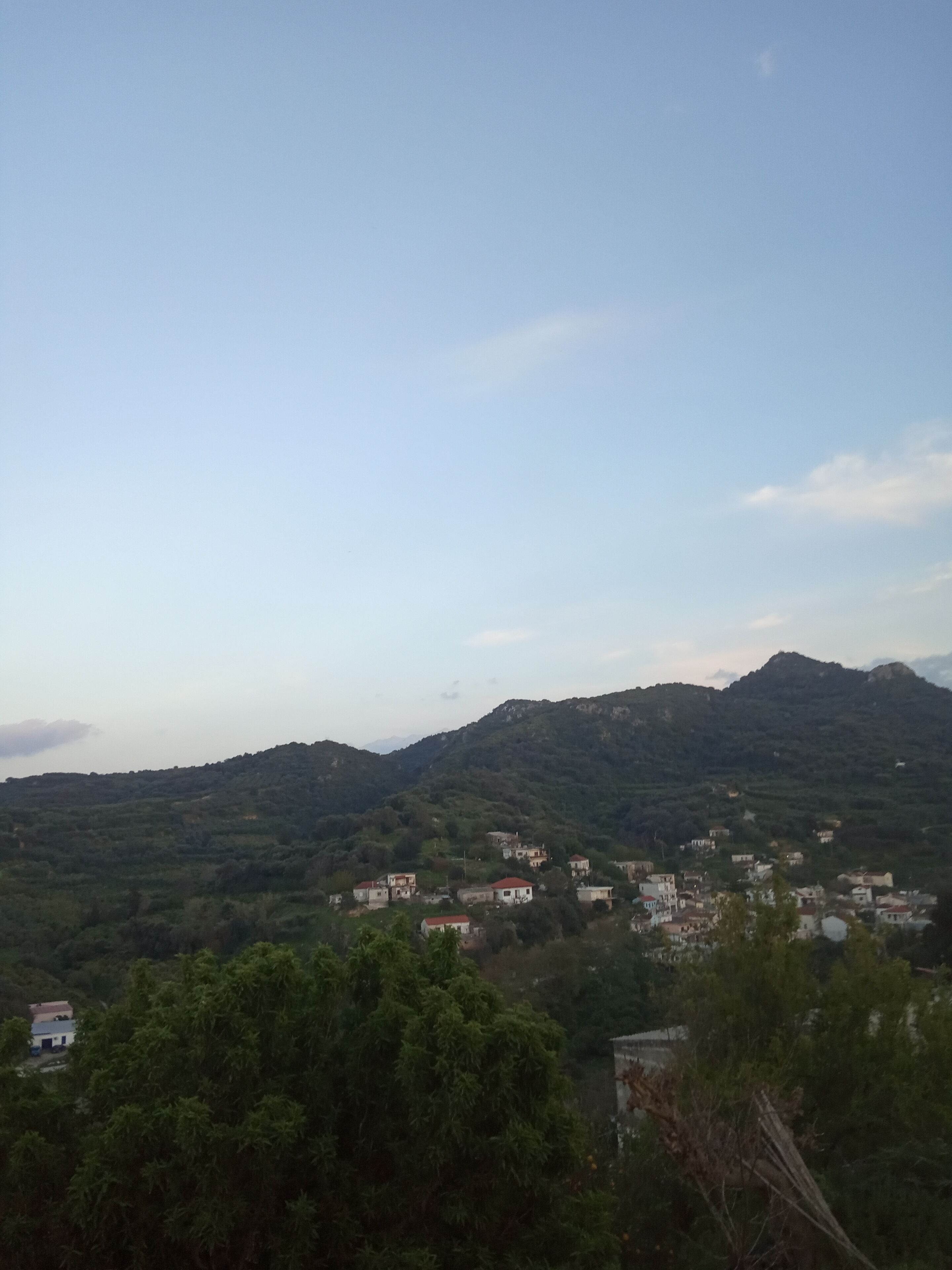 A mountainous landscape with scattered buildings.