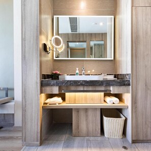 A modern bathroom with a large mirror, two sinks, and a vanity with storage. - Atour Hotel (Lhasa)