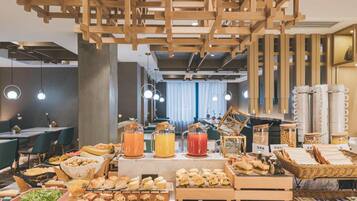 A breakfast buffet with various food items and beverages.