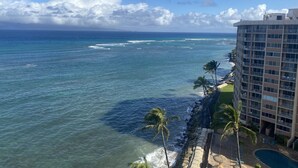 A hotel with a pool, ocean view, and palm trees. - Direct Oceanfront, unobstructed ocean view top floor penthouse quiet & private.  (Lahaina)