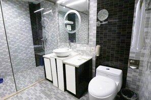 A modern bathroom with a glass-enclosed shower, a white sink, and a toilet. - Guangcheng Hotel (Pingliang)