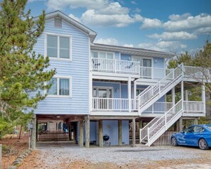 A two-story house with a front porch, a staircase, and a garage.