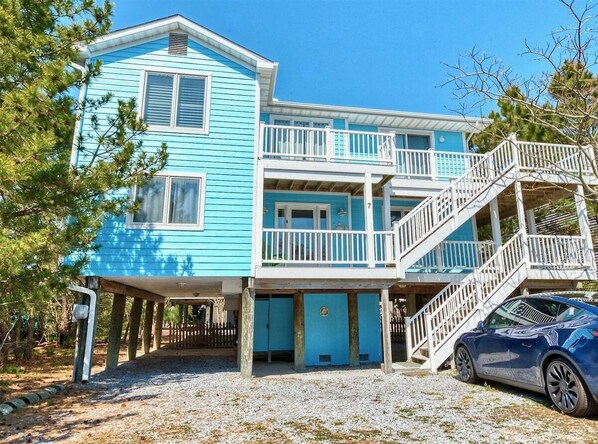 A two-story building with a balcony and a staircase.