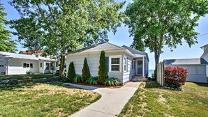 A single-story house with a front yard, a pathway leading to the entrance, and a small porch. - Fort Gratiot Lake House on Lake Huron w/ Patio & Deck! (Fort Gratiot Township)