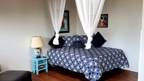A bedroom with a bed, a nightstand, a lamp, and a picture on the wall. - Ocean Beach #3, Breeze, Retro/Cozy, Studio Cottage only 3 blocks to beach!⛱ (San Diego)
