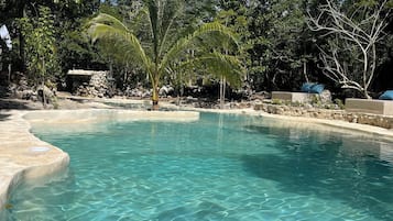 Alberca al aire libre y camastros