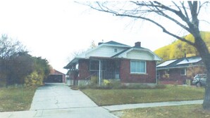 A two-story house with a front yard, a driveway, and a garage. - Entire basement apartment, Prime location! (Salt Lake City)