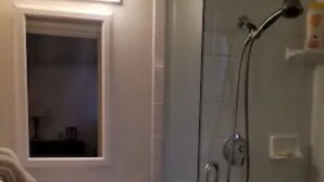 A bathroom with a glass shower enclosure, a sink with a mirror, and a towel hanging on the wall. - Entire basement apartment, Prime location! (Salt Lake City)