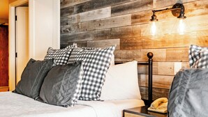 A bedroom with a wooden headboard, a bed with grey bedding, a bedside table with a lamp, and a telephone. - Shadow Ridge 401 | Walk to Lifts | Mtn & Ski Views | Kitchen | Fireplace | Updated | Pool & Hot Tub (Park City)