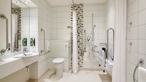 A modern bathroom with a shower, toilet, and sink. - Premier Inn Lymington (Lymington)