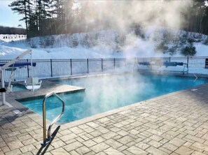 Relax by the heated pool surrounded by a serene natural setting.