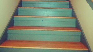 A staircase with wooden steps and a handrail, leading to a door at the top. - Comfortable retreat in the woods, but close to Island attractions (Mount Desert)