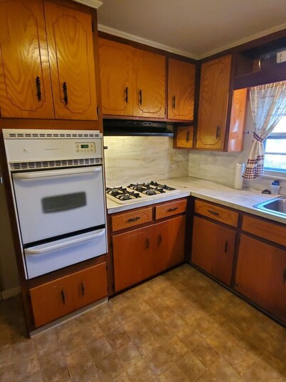 House with a full kitchen big backyard with trees