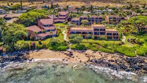 An aerial view of a resort with multiple buildings, a beach, and a rocky shoreline. - Kuleana 613 1 Bdrm 1 Bedroom Condo by RedAwning (Lahaina)