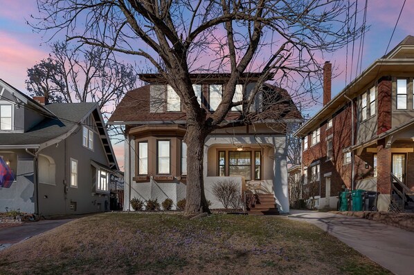 A two-story house with a large tree in front, a garage, and a driveway. - Oakley Square 3br Charmer - Total Walkability 3 Bedroom Home by RedAwning (Cincinnati)