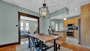 A modern kitchen with wooden cabinets, a stainless steel microwave, and an oven. - Oakley Square 3br Charmer - Total Walkability 3 Bedroom Home by RedAwning (Cincinnati)