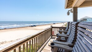 A wooden deck with benches overlooking a beach. - The Shore House 3 Bedroom Home by RedAwning (Port Bolivar)