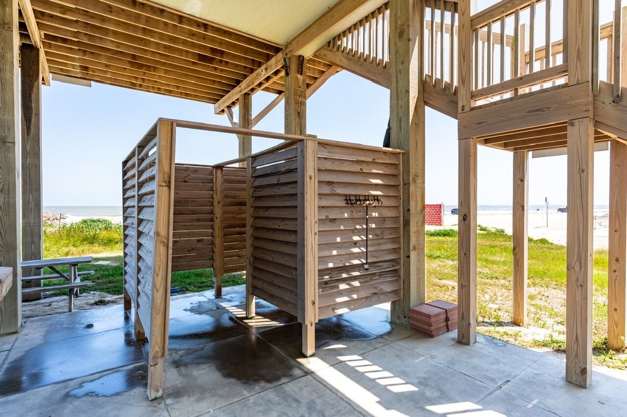 A wooden structure with a view of the beach and ocean.
