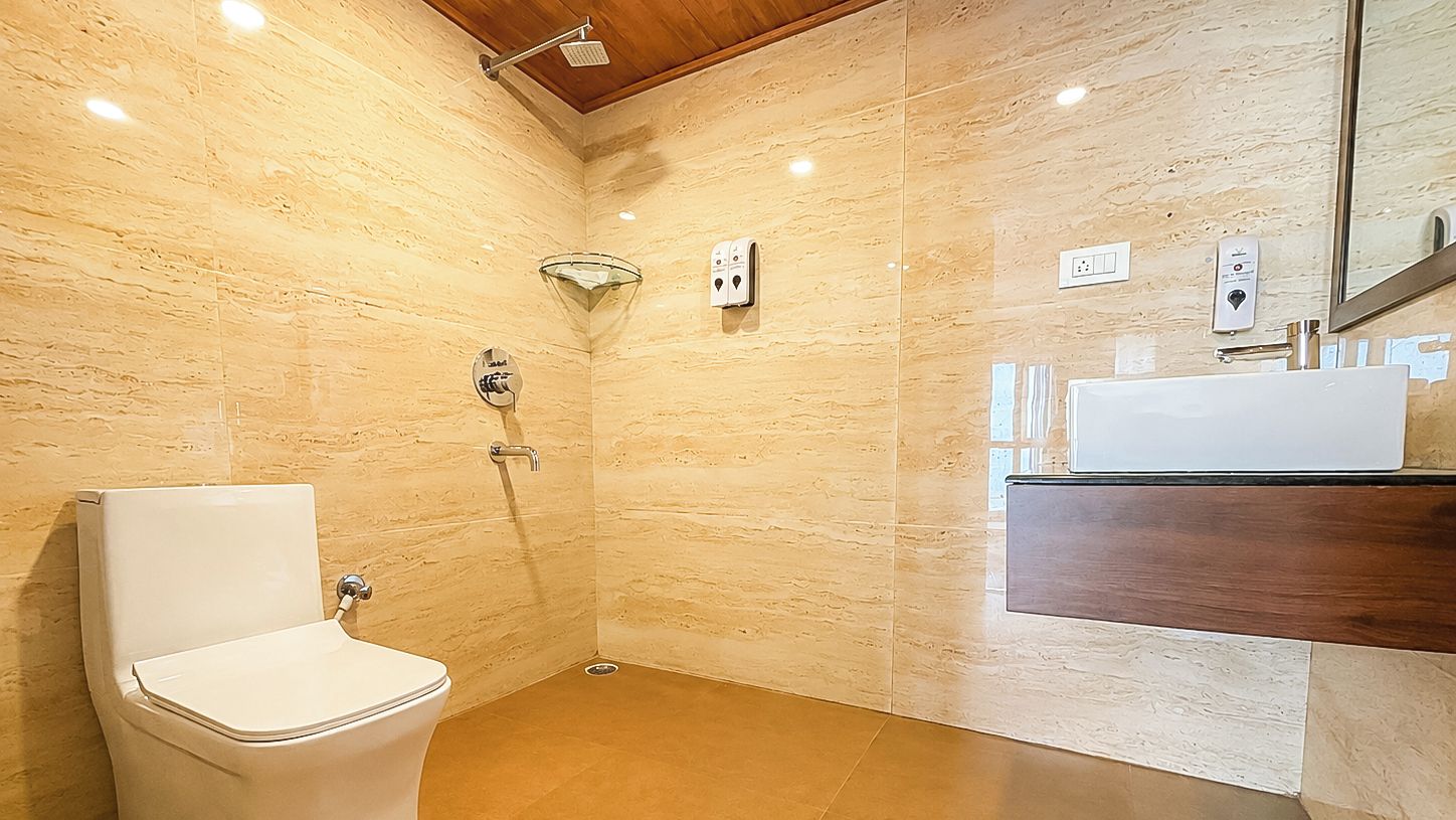 A modern bathroom with a toilet, shower, and vanity.