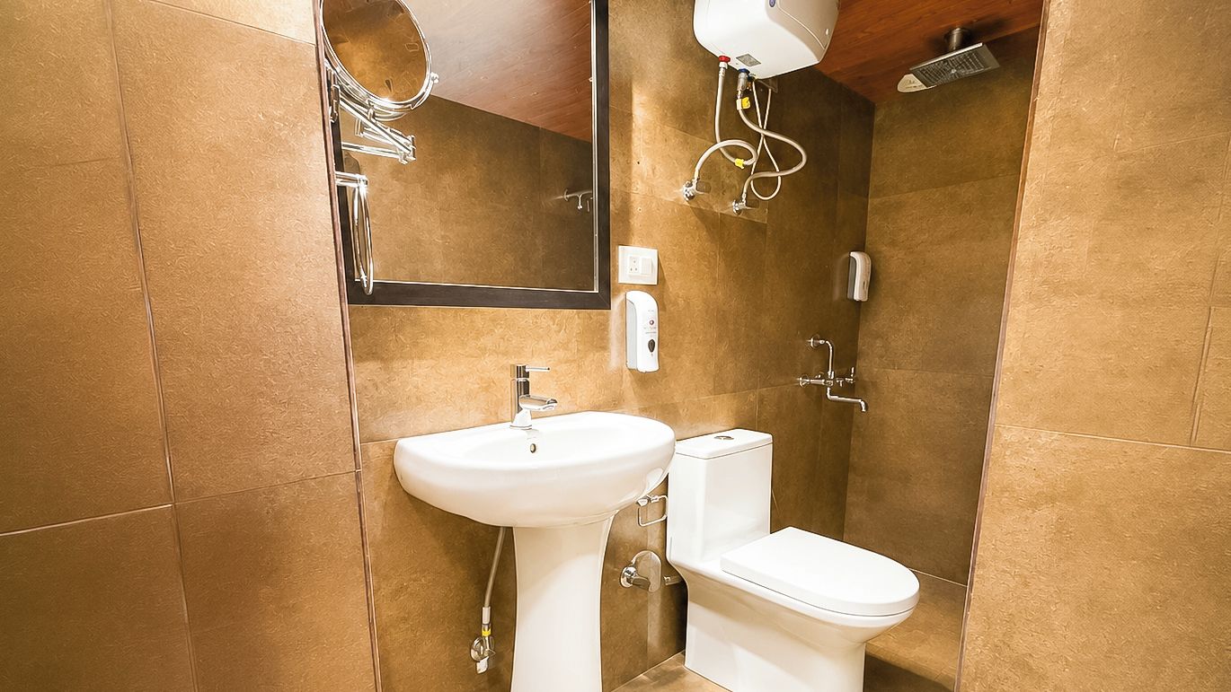 A bathroom with a sink, toilet, and shower.