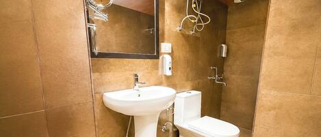 A bathroom with a sink, toilet, and shower.