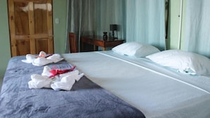 A hotel room with a bed, a desk, and a chair.
