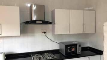 Apartment, 2 Bedrooms, Smoking, Garden View | Private kitchen | Fridge, microwave, cookware/dishes/utensils, dining tables