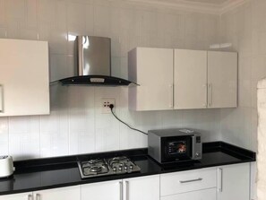 Apartment, 2 Bedrooms, Smoking, Garden View | Private kitchen | Fridge, microwave, cookware/dishes/utensils, dining tables - Exclusive Apartment in Handsworth - 2 Bedrooms (Lusaka)