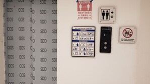 A wall with emergency signs, a fire evacuation map, and a lift control panel. - Aria Ocean 208 Beach Front Apartment Nuevo Vallarta (Nuevo Nayarit)