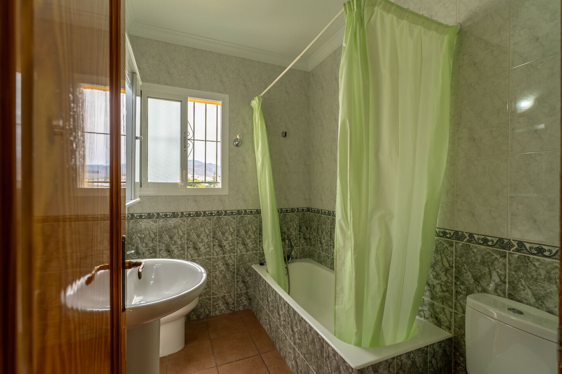 A bathroom with a bathtub, a sink, and a toilet.