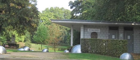 A building with a sign that reads 'Olle Danmarks,' surrounded by a grassy area with steps leading up to it.