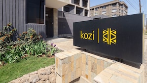 A building with a sign reading "kozi" and a modern design.