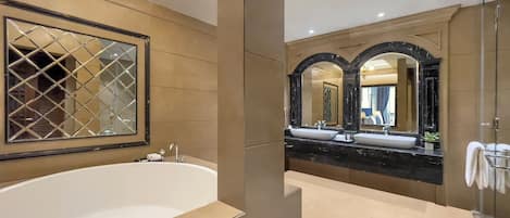 A modern bathroom with a large freestanding bathtub, a double sink vanity, and a large mirror.