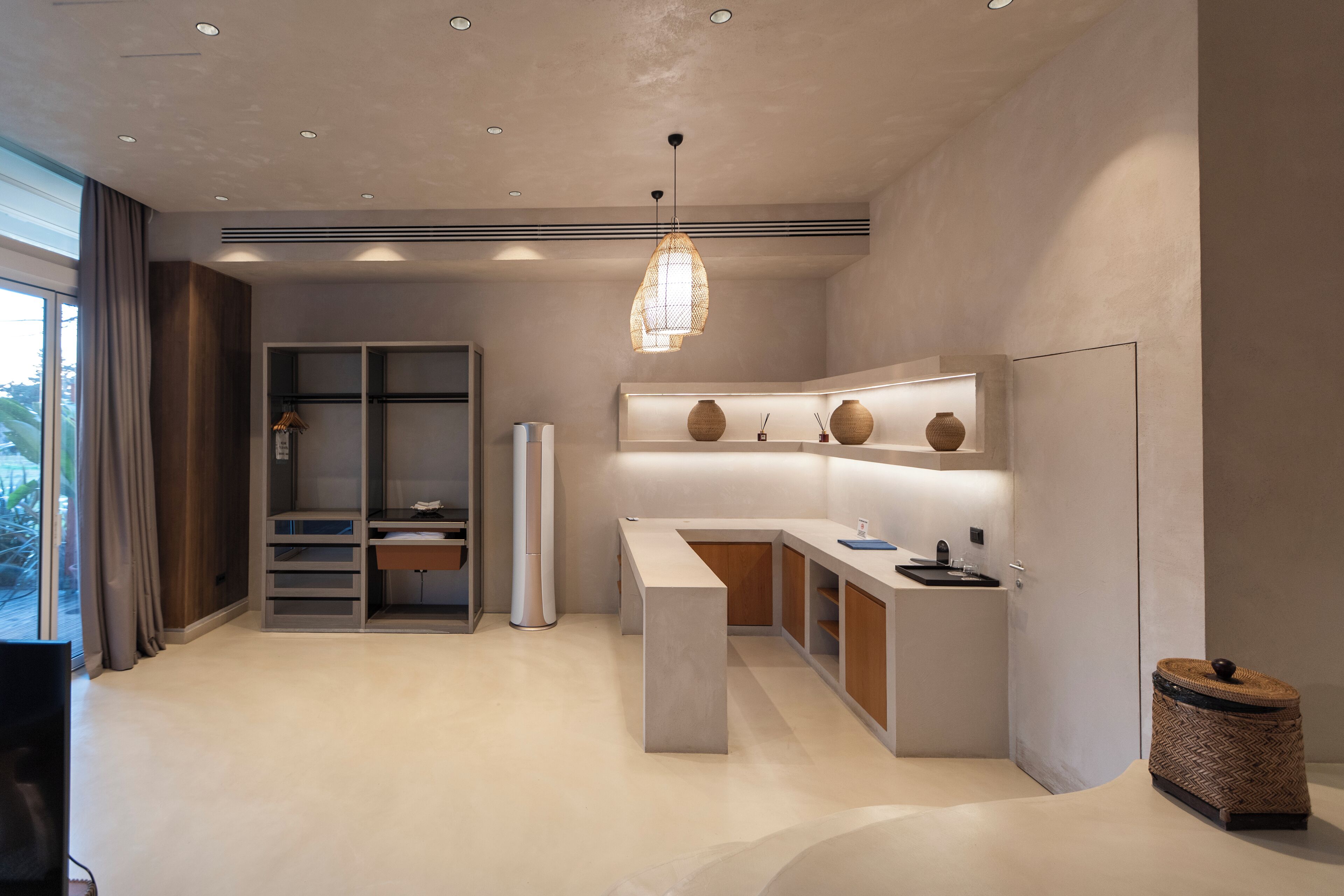A modern kitchen with a built-in island, a hanging pendant light, and a view of the outdoors.