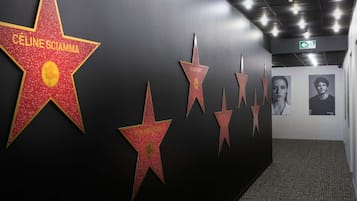 A hallway with a series of star-shaped decorations on the wall, each labeled with a name.