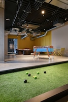 A billiards table with balls and a pool table in a modern indoor setting.