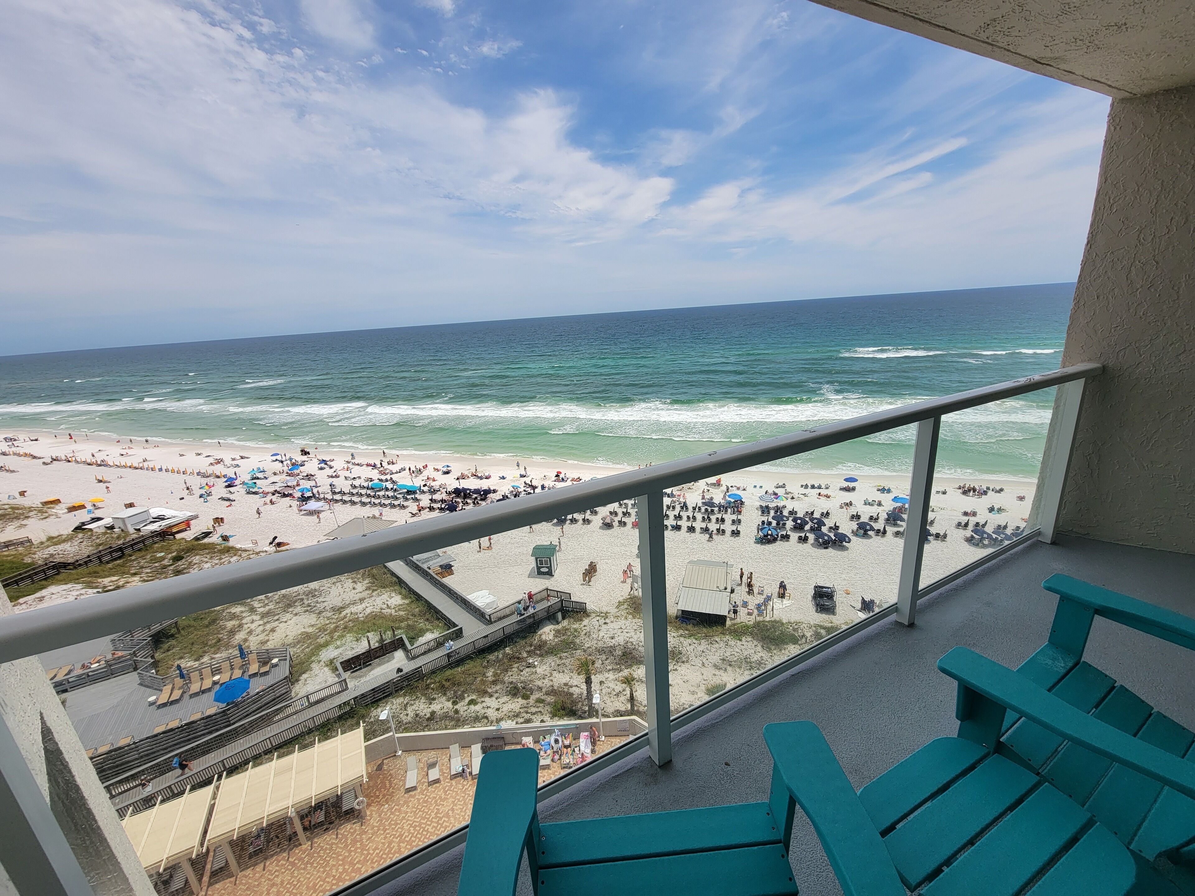 A balcony with a view of a beach and ocean.