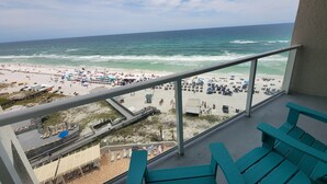 Un balcon avec vue sur une plage et l’océan.