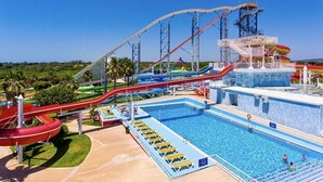 A water park with multiple slides and a swimming pool. - Albufeira Beach Apartment with sea views of the Bay all the way to the Old Town (Albufeira)