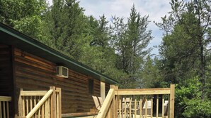 A wooden cabin with a wooden deck and stairs leading to a porch. - Private cabin with direct ATV/UTV trail access (Fairchild)