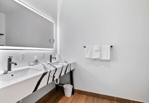 A modern bathroom with two sinks, a large mirror, and a towel rack. - Spacious Loft 2 bedroom in N Oakland 400, sleeps 8 (Pittsburgh)